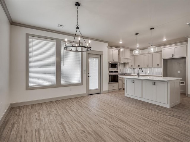 6609 NW 147th St, Oklahoma City, OK 73142 - kitchen with stainless steel appliances, a chandelier, light countertops, ornamental molding, and white cabinetry