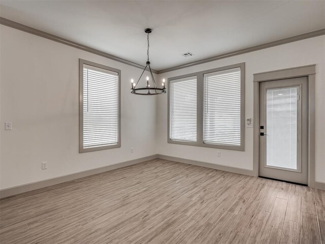 6609 NW 147th St, Oklahoma City, OK 73142 - unfurnished room with a chandelier, ornamental molding, and light wood-style floors