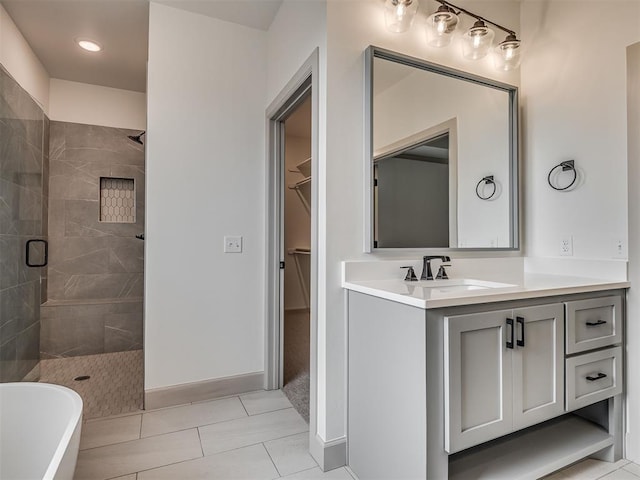 6609 NW 147th St, Oklahoma City, OK 73142 - full bathroom with a stall shower, vanity, a spacious closet, a freestanding bath, and tile patterned floors