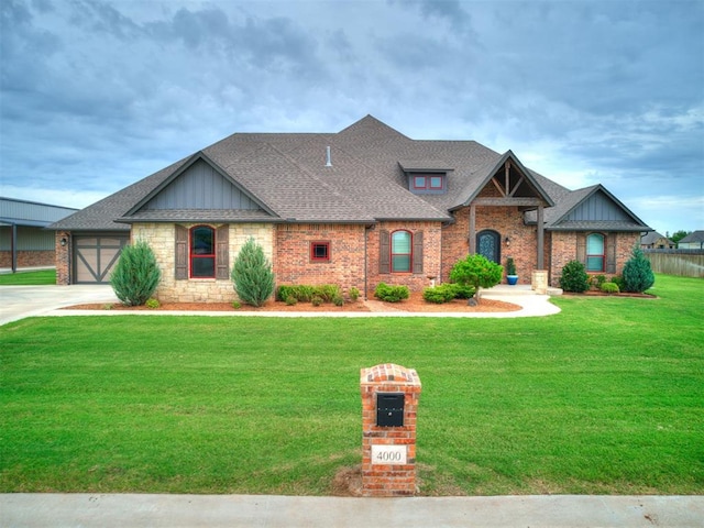 4000 Timber Creek Way, Moore, OK 73165 - craftsman-style home with board and batten siding, a front yard, a shingled roof, driveway, and brick siding