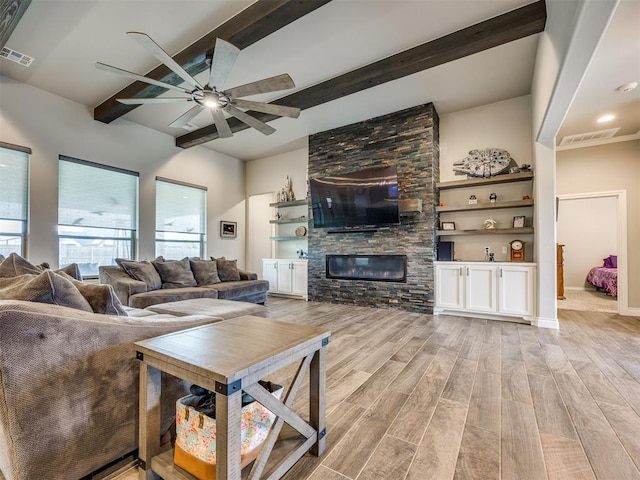 4000 Timber Creek Way, Moore, OK 73165 - living area featuring ceiling fan, beam ceiling, light wood-style floors, and a stone fireplace