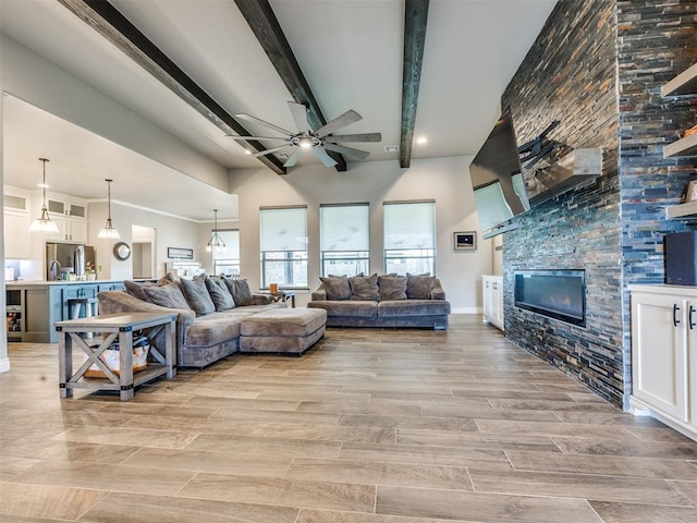 4000 Timber Creek Way, Moore, OK 73165 - living room with ceiling fan, a stone fireplace, beam ceiling, and light wood-type flooring