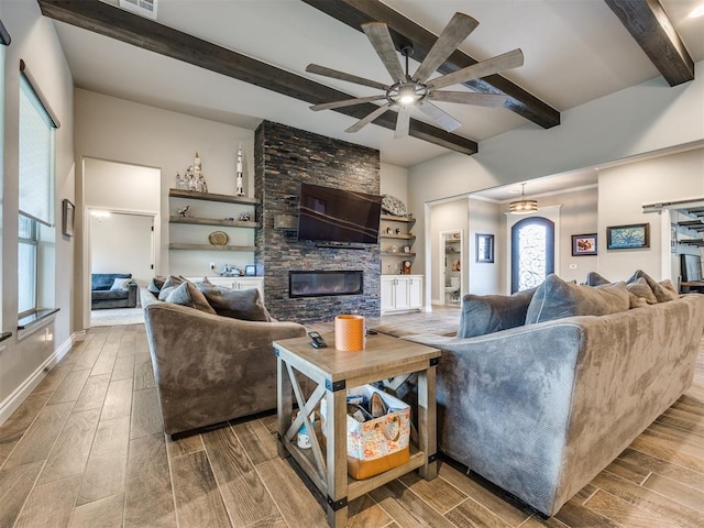 4000 Timber Creek Way, Moore, OK 73165 - living area featuring beamed ceiling, wood finish floors, ceiling fan, and a fireplace