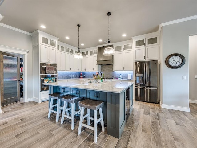 4000 Timber Creek Way, Moore, OK 73165 - kitchen featuring stainless steel fridge, ornamental molding, white cabinets, backsplash, and light wood-style flooring