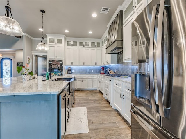 4000 Timber Creek Way, Moore, OK 73165 - kitchen featuring appliances with stainless steel finishes, white cabinetry, wall chimney range hood, decorative backsplash, and crown molding