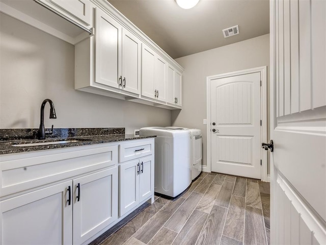 4000 Timber Creek Way, Moore, OK 73165 - washroom with washer and dryer, cabinet space, and wood finish floors