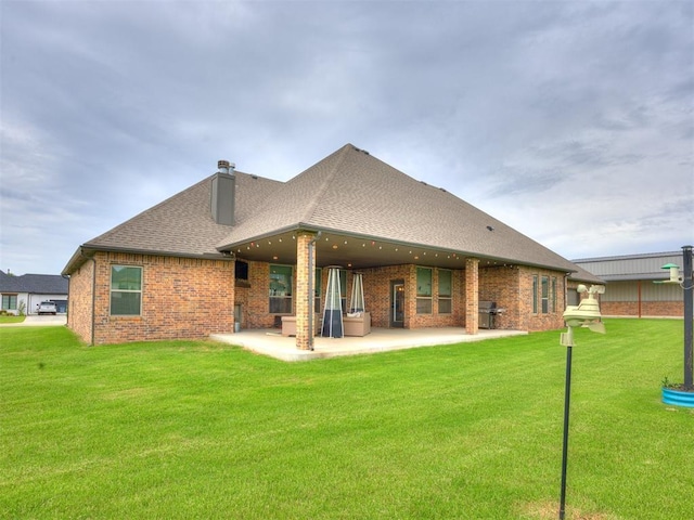 4000 Timber Creek Way, Moore, OK 73165 - rear view of property featuring a patio, a chimney, brick siding, a shingled roof, and a lawn