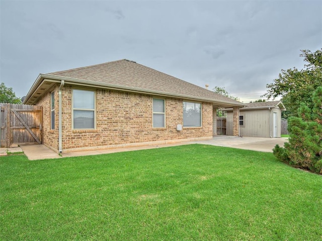 10808 Cheshire Ct, Yukon, OK 73099 - rear view of house with brick siding, a patio, and roof with shingles