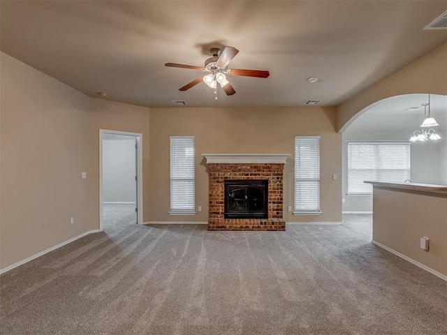 4513 SE 79th Ter, Oklahoma City, OK 73135 - unfurnished living room with ceiling fan, carpet, arched walkways, and a brick fireplace