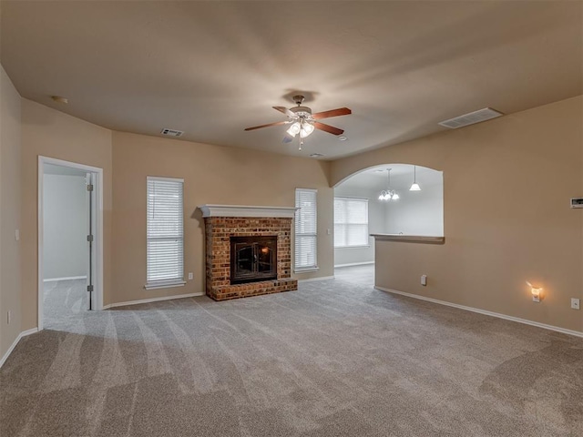 4513 SE 79th Ter, Oklahoma City, OK 73135 - unfurnished living room with ceiling fan, carpet, arched walkways, and a fireplace