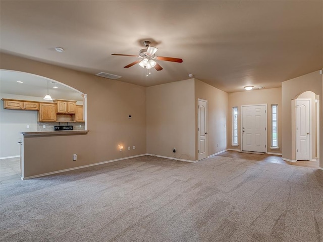 4513 SE 79th Ter, Oklahoma City, OK 73135 - unfurnished living room with arched walkways, a ceiling fan, and carpet floors