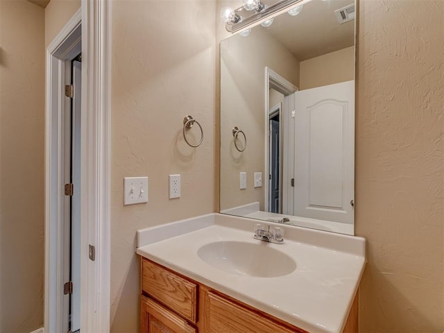 4513 SE 79th Ter, Oklahoma City, OK 73135 - bathroom featuring vanity and a textured wall