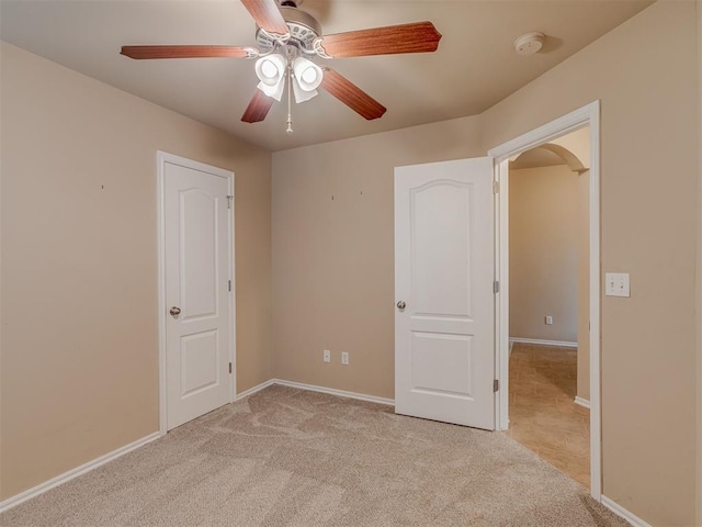 4513 SE 79th Ter, Oklahoma City, OK 73135 - carpeted empty room featuring a ceiling fan, a smoke detector, and arched walkways
