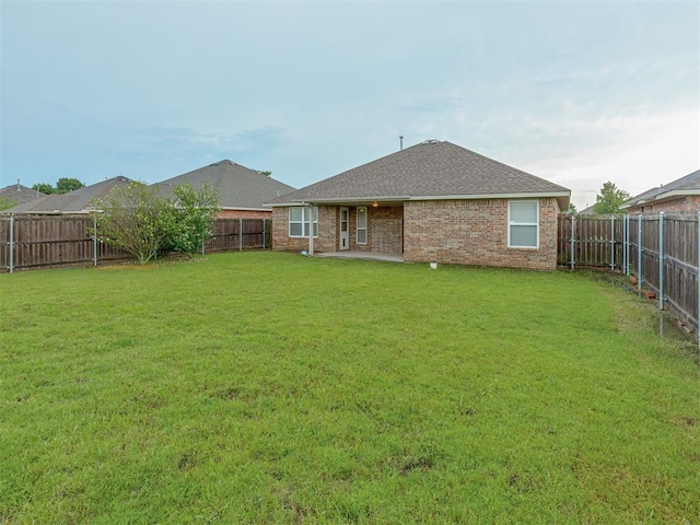 4513 SE 79th Ter, Oklahoma City, OK 73135 - rear view of property featuring a fenced backyard, brick siding, and roof with shingles