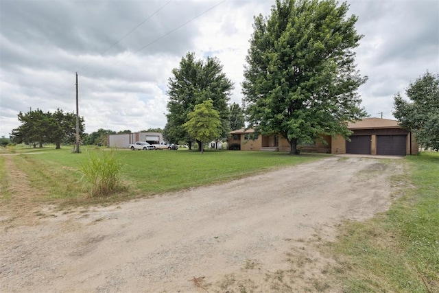 104951 S 3440th Rd, Meeker, OK 74855 - view of front of property featuring dirt driveway, an attached garage, and a front lawn