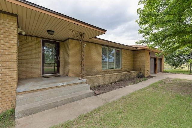 104951 S 3440th Rd, Meeker, OK 74855 - doorway to property with concrete driveway, a garage, and brick siding