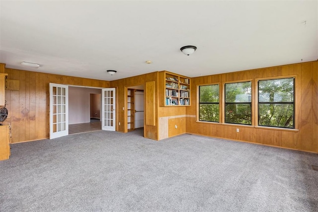 104951 S 3440th Rd, Meeker, OK 74855 - unfurnished room with french doors, wood walls, and carpet floors