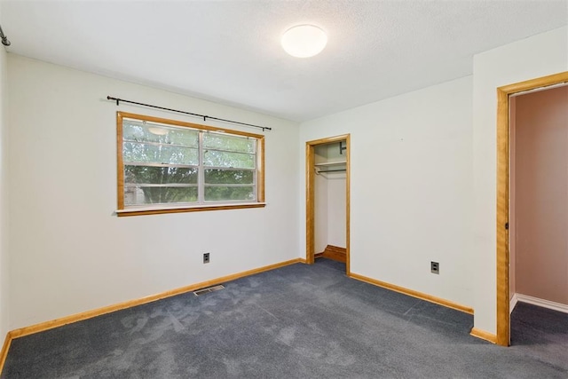104951 S 3440th Rd, Meeker, OK 74855 - unfurnished bedroom featuring dark colored carpet and a closet