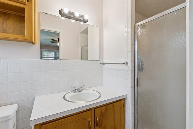 104951 S 3440th Rd, Meeker, OK 74855 - bathroom with vanity, a stall shower, decorative backsplash, ceiling fan, and tile walls