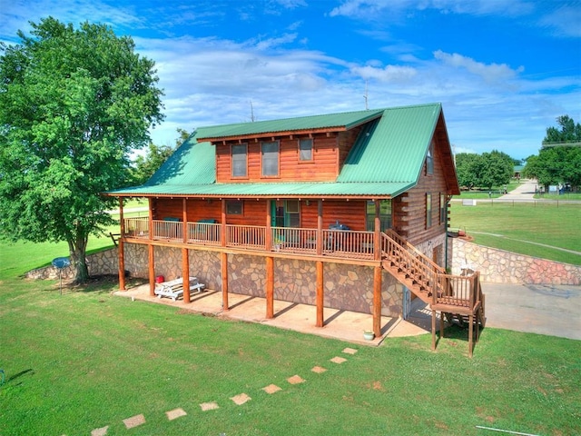 15701 S Pennsylvania Ave, Oklahoma City, OK 73170 - back of house featuring a yard, stone siding, and a metal roof