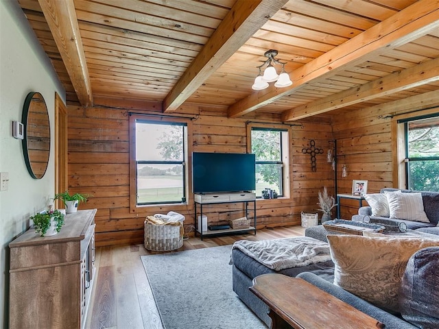 15701 S Pennsylvania Ave, Oklahoma City, OK 73170 - living room with a wooden ceiling with exposed beams, wood-type flooring, wood walls, and a chandelier