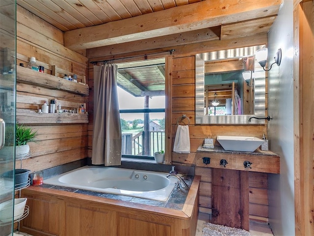 15701 S Pennsylvania Ave, Oklahoma City, OK 73170 - bathroom with wooden walls, a whirlpool tub, wooden ceiling, and vanity