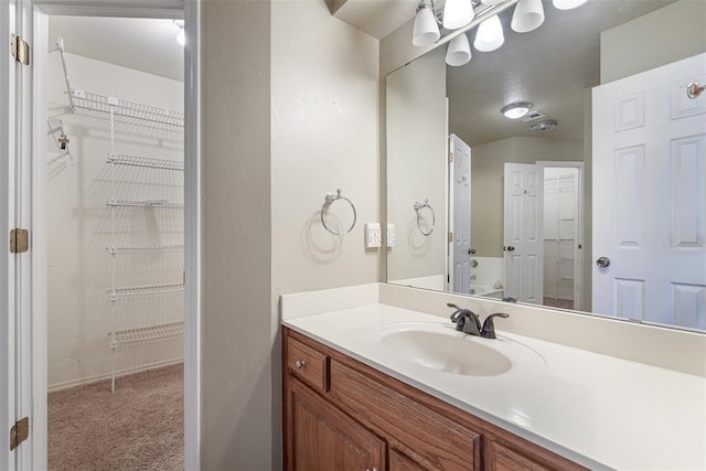 1709 Rocky Mountain Way, Edmond, OK 73003 - bathroom with vanity and a spacious closet