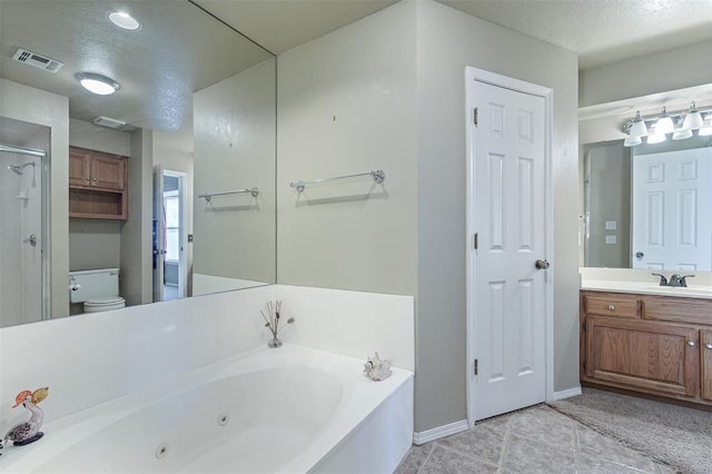 1709 Rocky Mountain Way, Edmond, OK 73003 - bathroom featuring a tub with jets, vanity, tile patterned flooring, a textured ceiling, and a stall shower