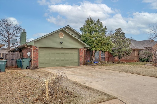 1709 Rocky Mountain Way, Edmond, OK 73003 - view of front of house with brick siding, driveway, a garage, and a chimney