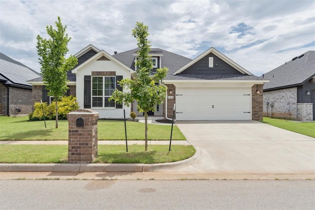 808 Scully Rd, Yukon, OK 73099 - view of front of house with a front lawn, driveway, a garage, brick siding, and roof with shingles