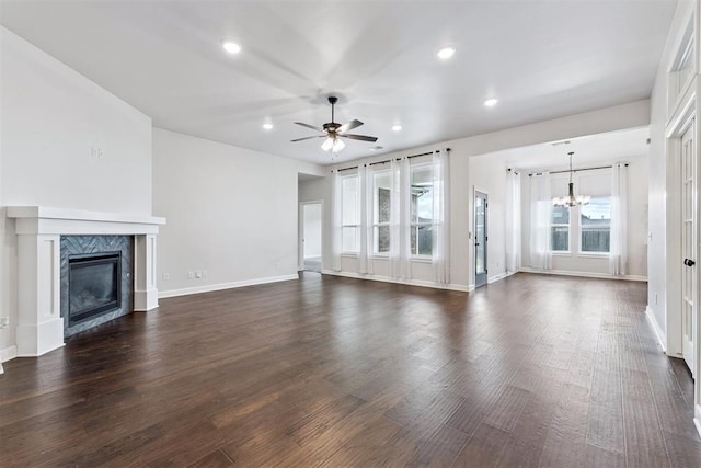 808 Scully Rd, Yukon, OK 73099 - unfurnished living room with a chandelier, a high end fireplace, a ceiling fan, dark wood finished floors, and recessed lighting