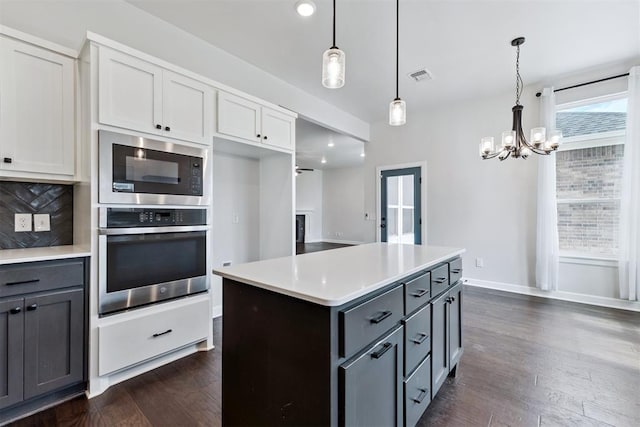 808 Scully Rd, Yukon, OK 73099 - kitchen featuring oven, built in microwave, gray cabinetry, and a chandelier