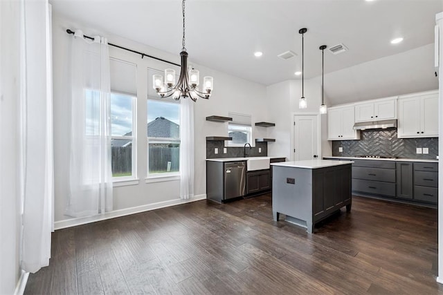 808 Scully Rd, Yukon, OK 73099 - kitchen featuring stainless steel dishwasher, light countertops, open shelves, a chandelier, and backsplash