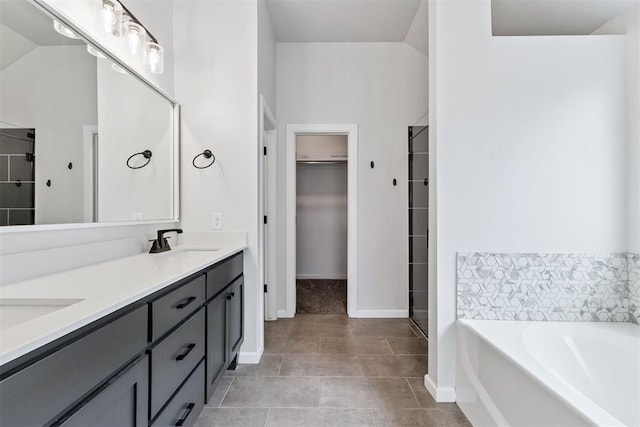 808 Scully Rd, Yukon, OK 73099 - bathroom featuring a spacious closet, double vanity, a stall shower, and a bath