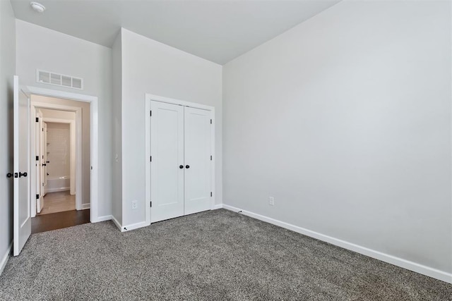 808 Scully Rd, Yukon, OK 73099 - unfurnished bedroom featuring dark colored carpet and a closet