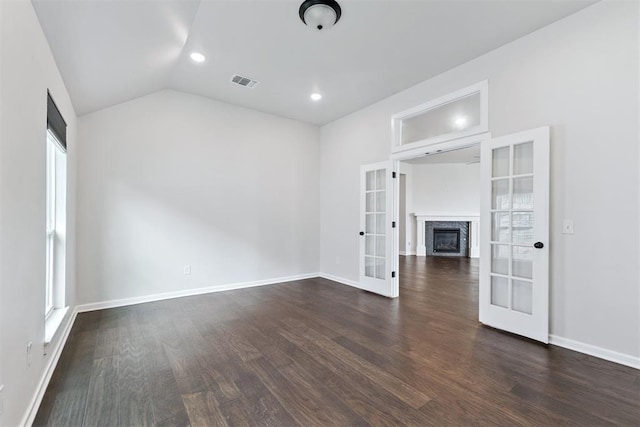 808 Scully Rd, Yukon, OK 73099 - unfurnished living room featuring french doors, dark wood-type flooring, lofted ceiling, recessed lighting, and plenty of natural light