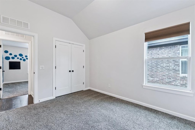 808 Scully Rd, Yukon, OK 73099 - unfurnished bedroom featuring dark carpet, lofted ceiling, and a closet