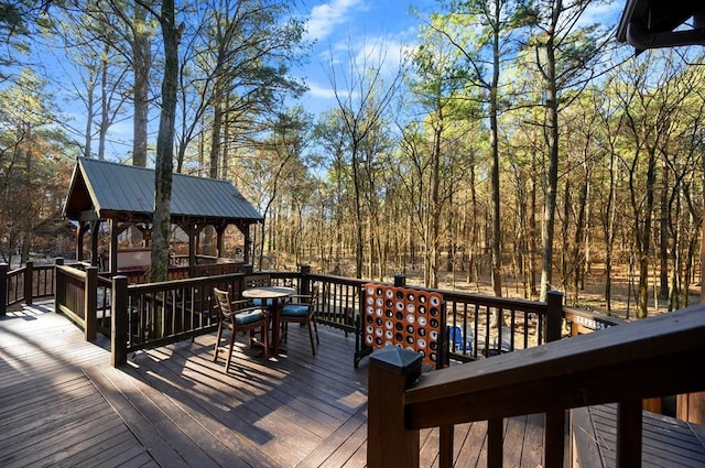 123 Hemlock Grove Rd, Hochatown, OK 74728 - wooden terrace featuring a gazebo and outdoor dining space
