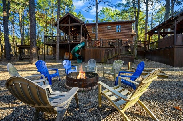 123 Hemlock Grove Rd, Hochatown, OK 74728 - view of patio / terrace featuring an outdoor fire pit, stairs, a wooden deck, and a ceiling fan