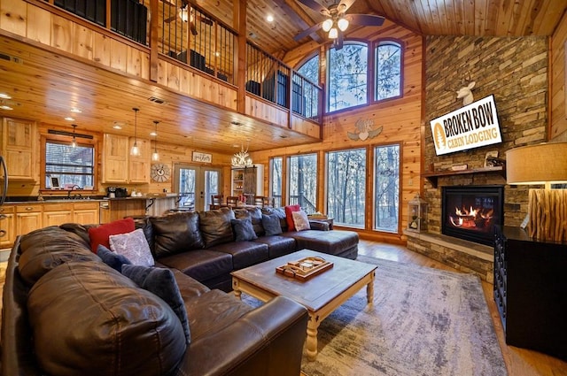 123 Hemlock Grove Rd, Hochatown, OK 74728 - living room with wood ceiling, a fireplace, high vaulted ceiling, wood finished floors, and ceiling fan