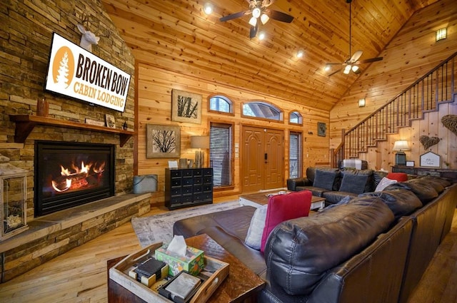 123 Hemlock Grove Rd, Hochatown, OK 74728 - living room with ceiling fan, high vaulted ceiling, hardwood / wood-style flooring, stairway, and a stone fireplace