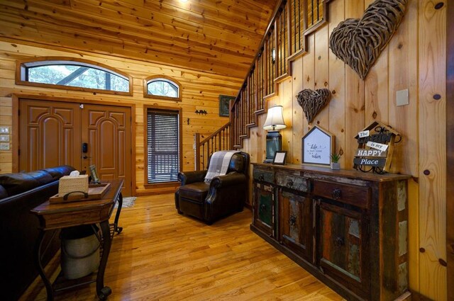 123 Hemlock Grove Rd, Hochatown, OK 74728 - entryway with stairway, wood walls, light wood-style flooring, high vaulted ceiling, and wood ceiling