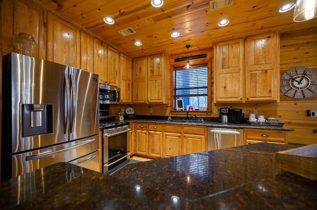 123 Hemlock Grove Rd, Hochatown, OK 74728 - kitchen featuring appliances with stainless steel finishes, dark stone countertops, wood ceiling, recessed lighting, and brown cabinets