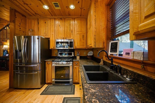 123 Hemlock Grove Rd, Hochatown, OK 74728 - kitchen featuring stainless steel appliances, brown cabinets, wooden ceiling, light wood-style floors, and recessed lighting
