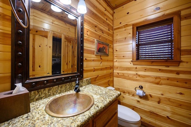 123 Hemlock Grove Rd, Hochatown, OK 74728 - bathroom featuring vanity and wood walls