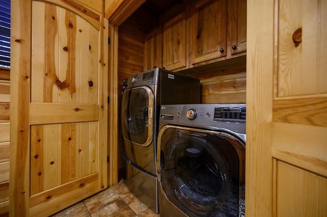 123 Hemlock Grove Rd, Hochatown, OK 74728 - laundry room featuring cabinet space, washing machine and dryer, and wooden walls