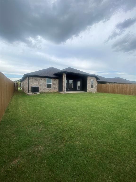 12616 NW 4th St, Yukon, OK 73099 - back of property with a fenced backyard and brick siding