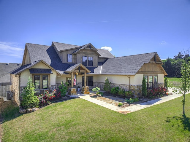 7308 Sunset Sail Ave, Edmond, OK 73034 - craftsman-style house featuring stucco siding, stone siding, a front lawn, and a shingled roof