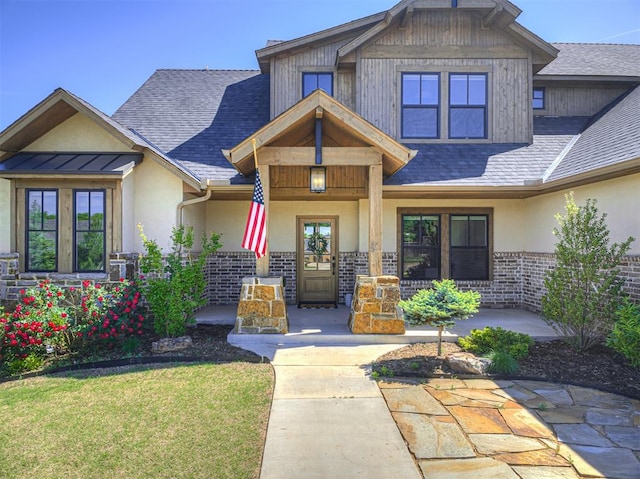 7308 Sunset Sail Ave, Edmond, OK 73034 - craftsman inspired home with stucco siding, a porch, a shingled roof, and brick siding