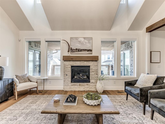 7308 Sunset Sail Ave, Edmond, OK 73034 - living room featuring plenty of natural light, vaulted ceiling, a fireplace, and wood finished floors